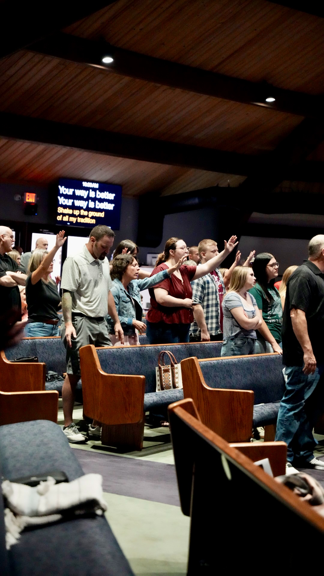 Congregation singing with hands lifted