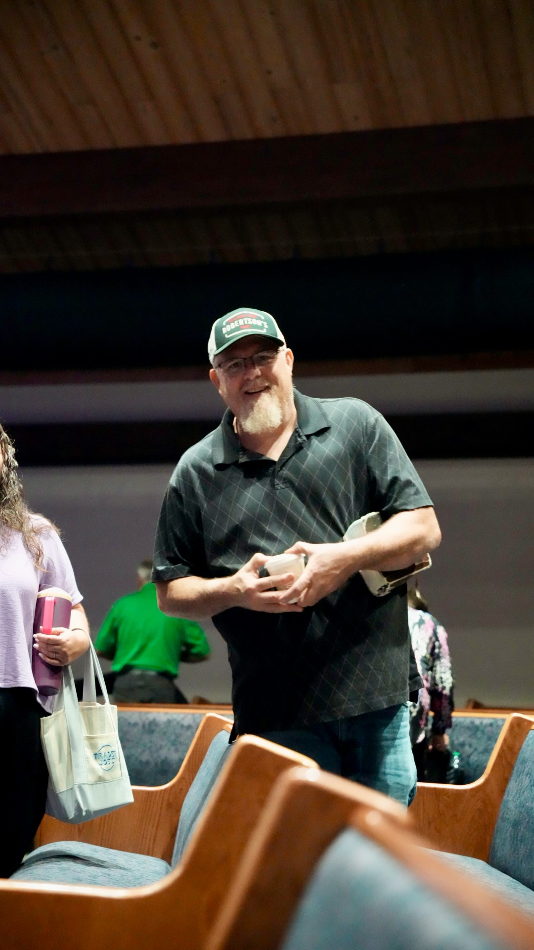 A smiling church member with coffee and his Bible