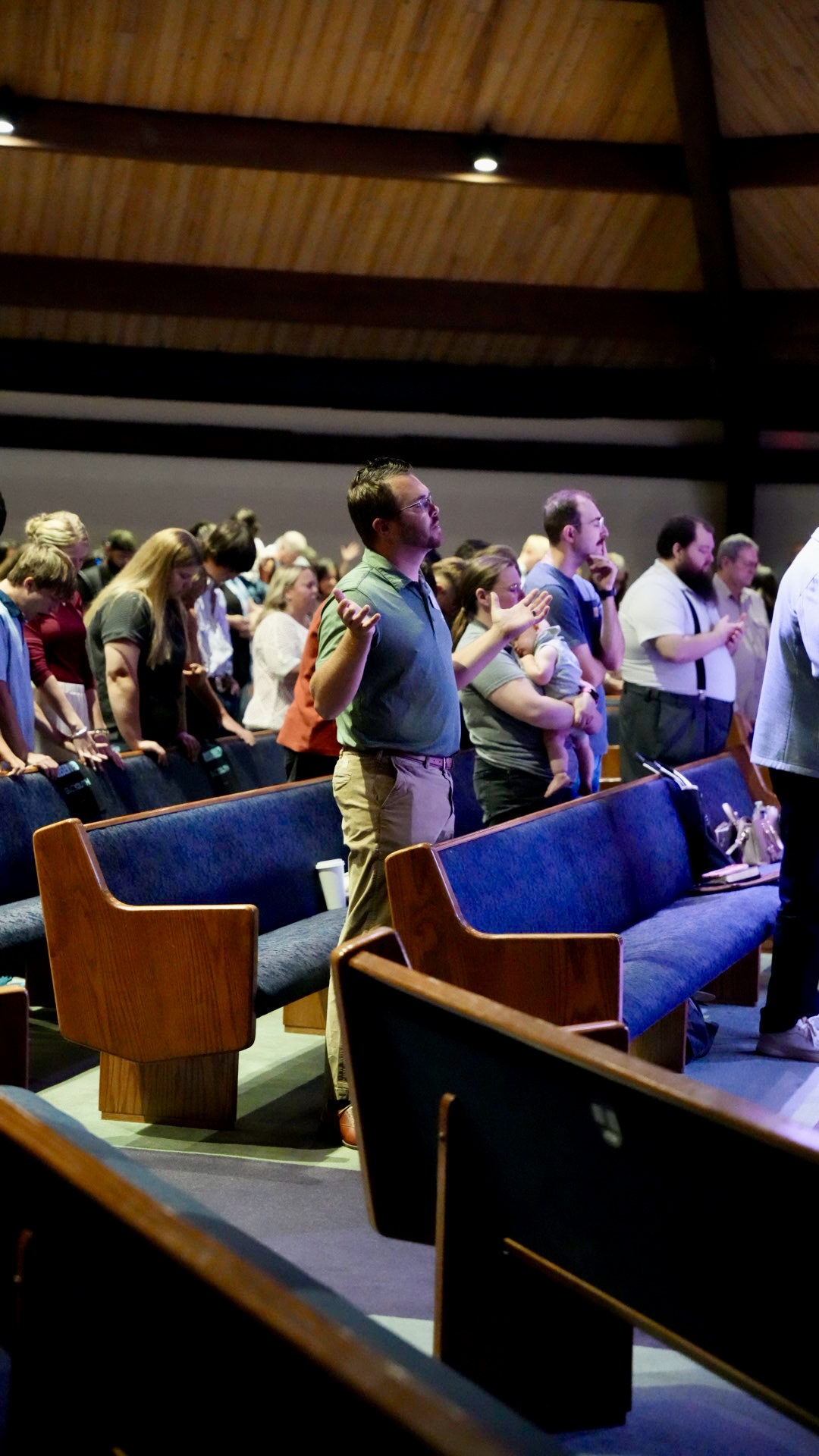 The congregation standing in prayer