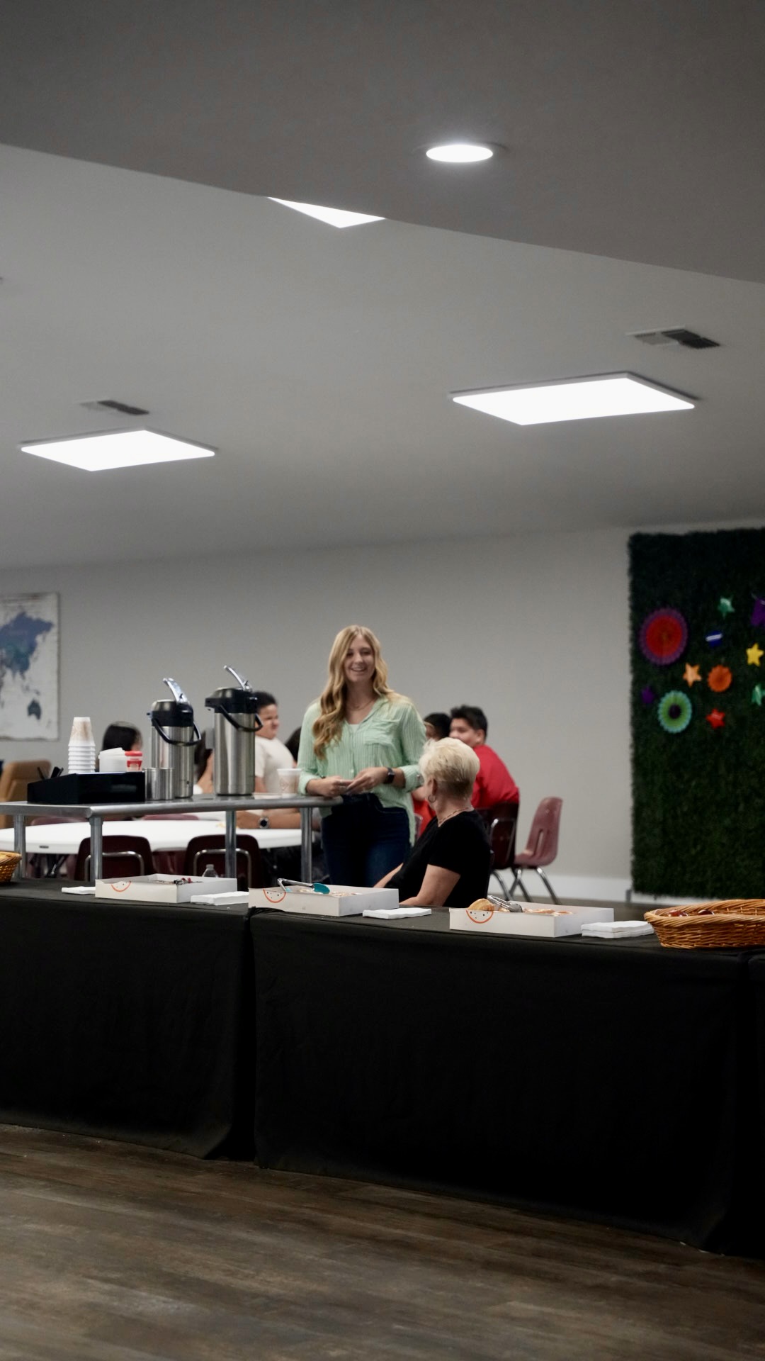 Volunteers serving coffee and donuts in the fellowship hall