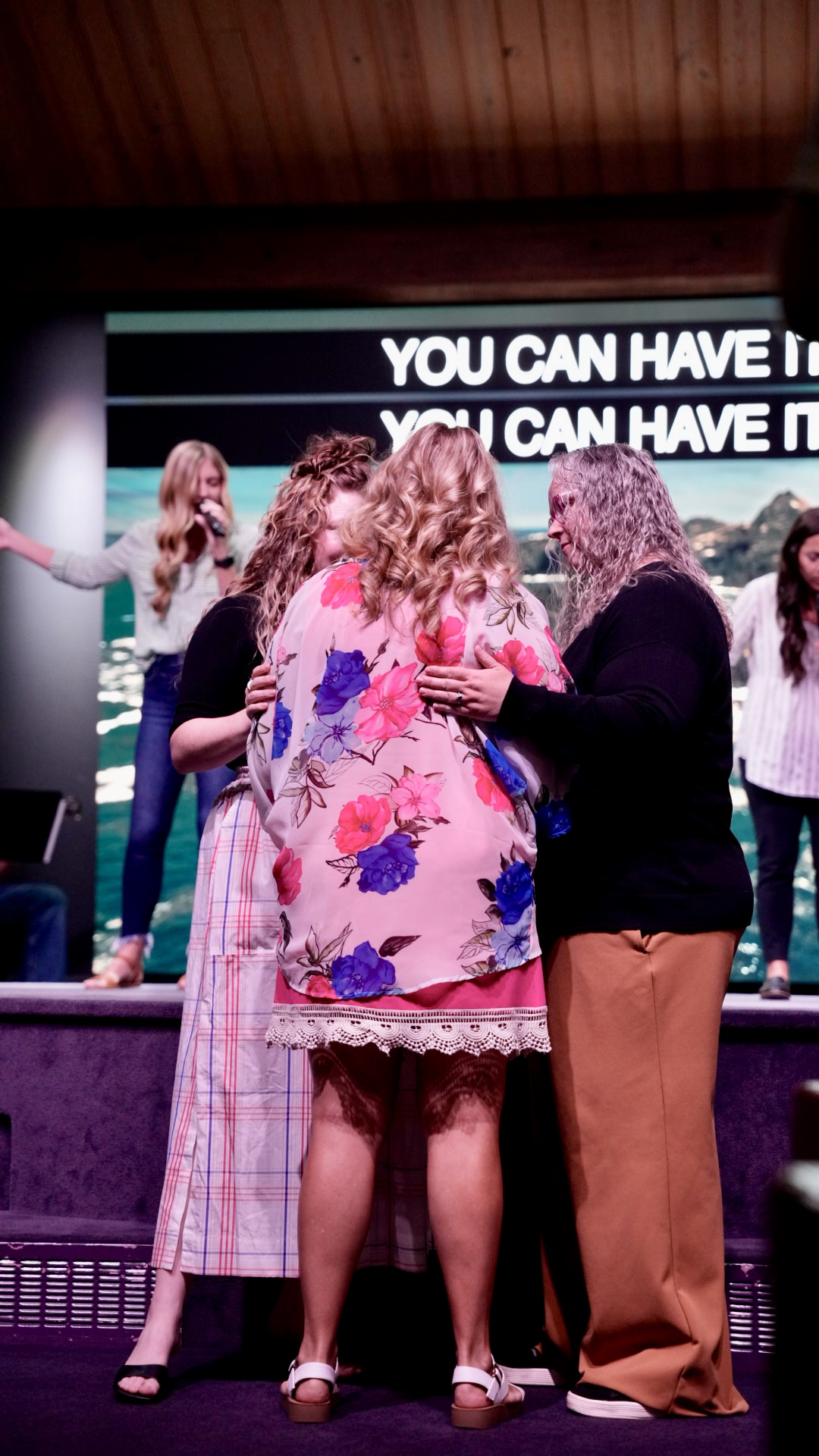 Women praying and embracing at the altar