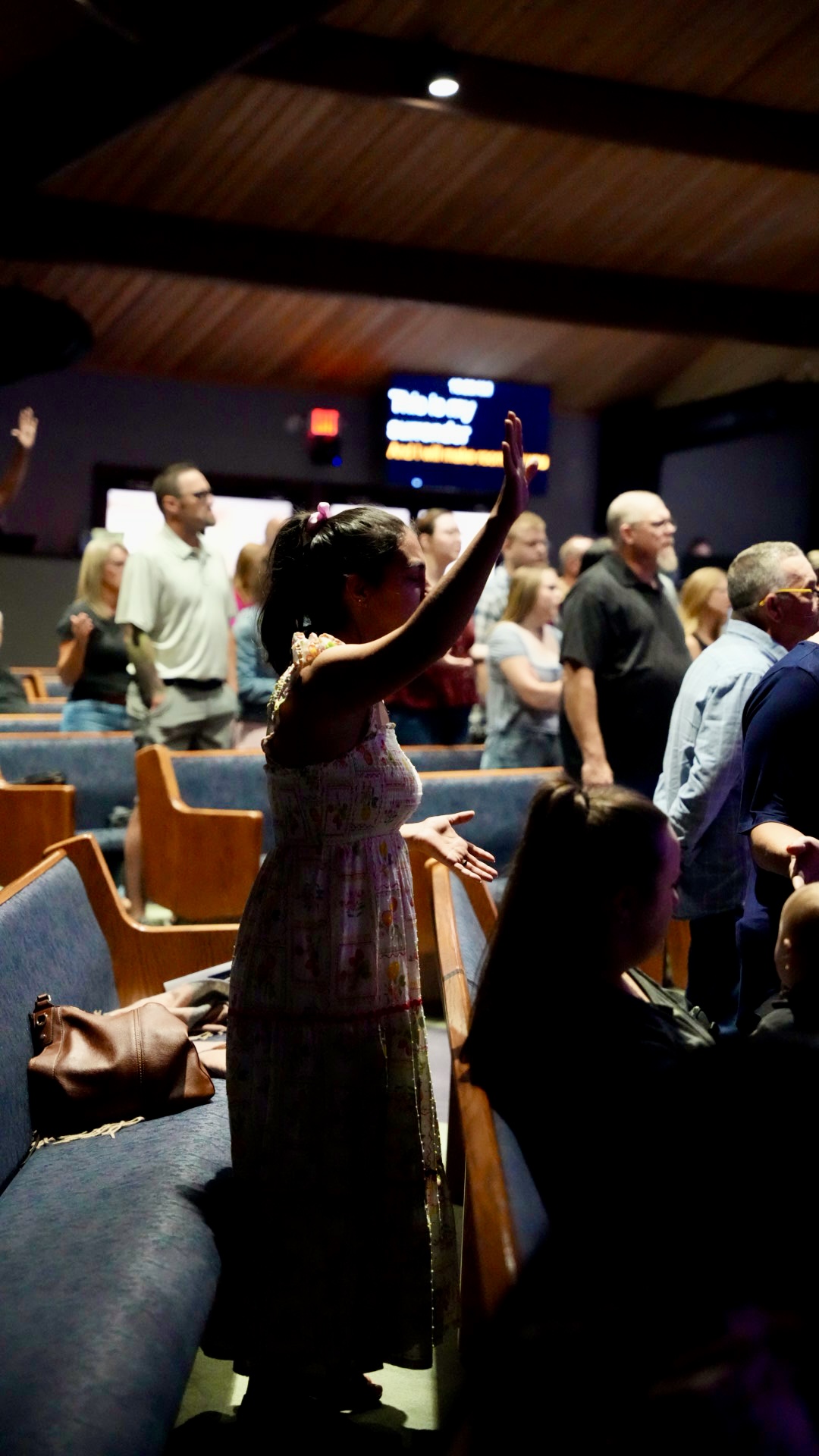 A woman worshipping during the service