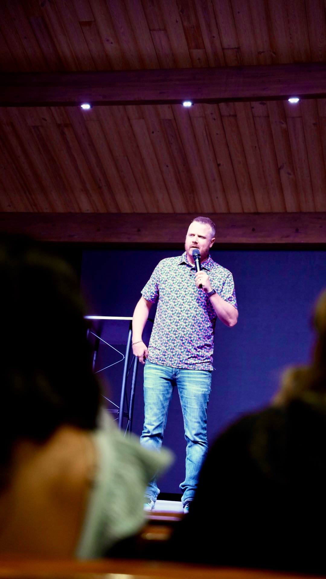 Pastor preaching with a microphone on stage