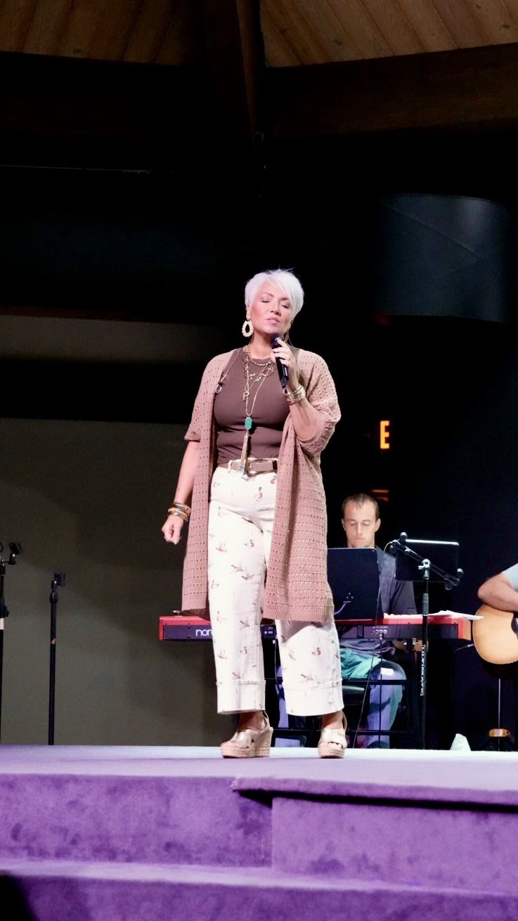 A vocalist leading worship on stage