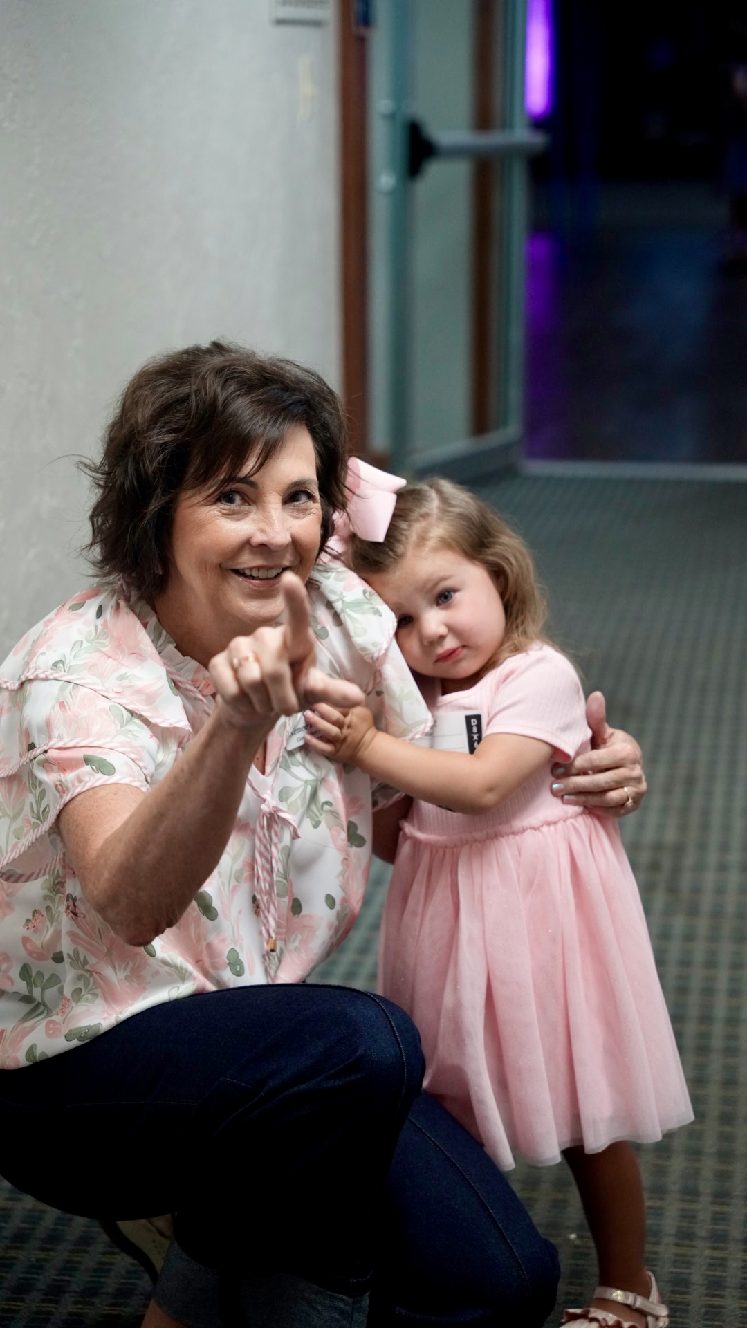 A kids ministry volunteer with a little girl