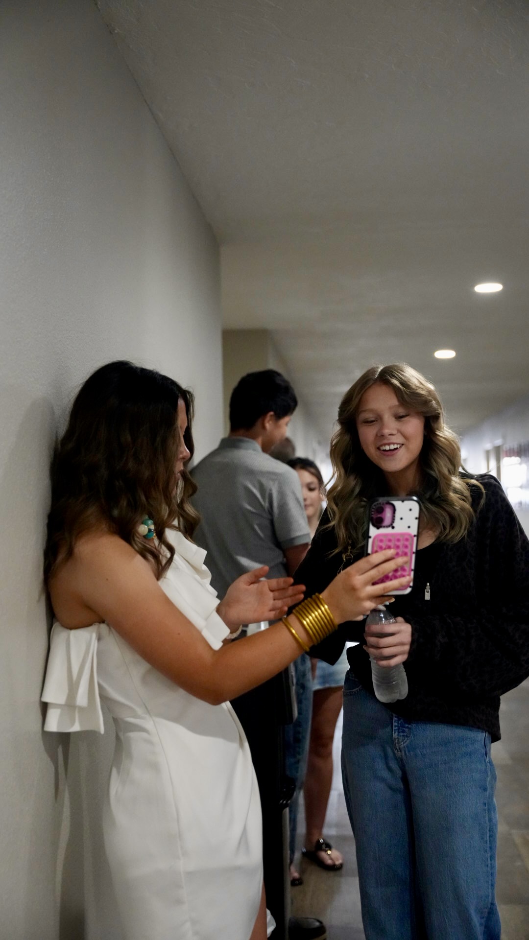 Teen girls laughing together in the hallway
