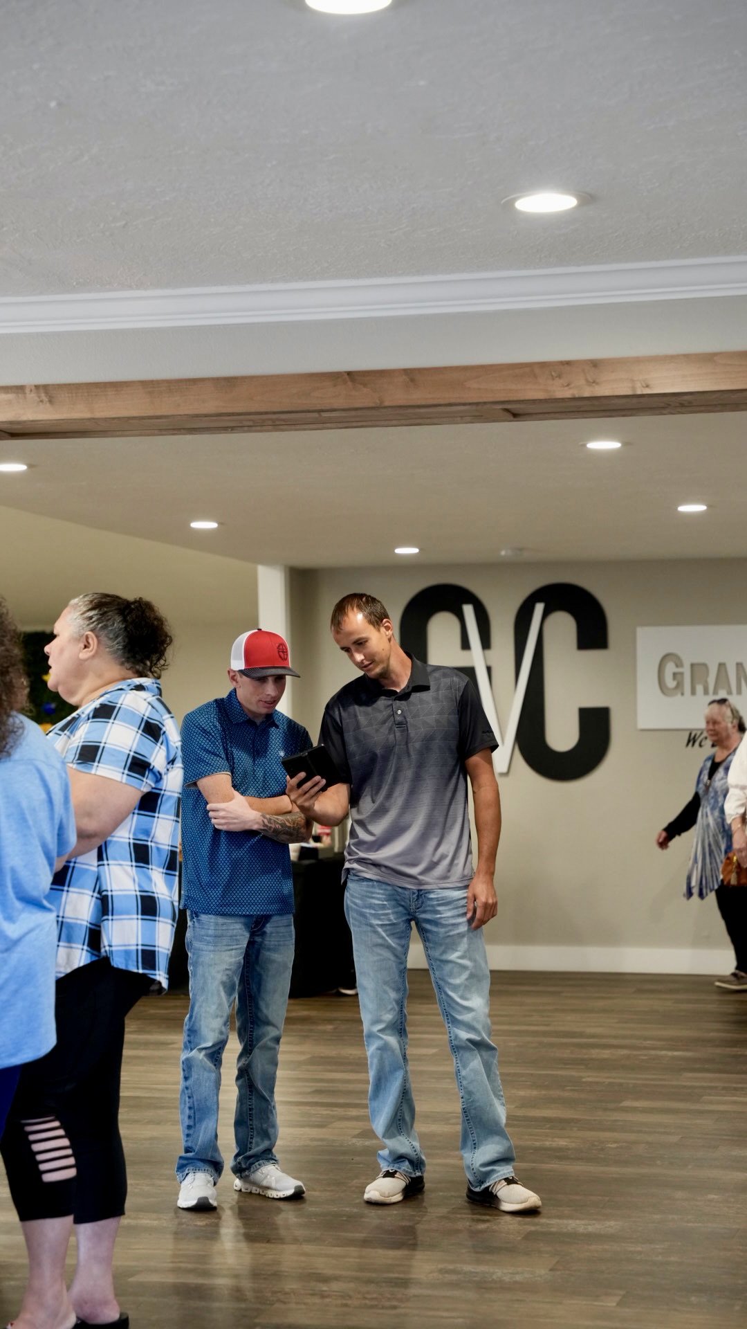 Two men talking in the GVC lobby before service