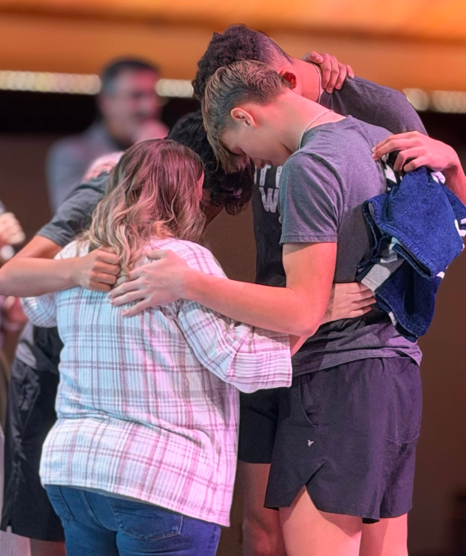 A group huddled together in prayer
