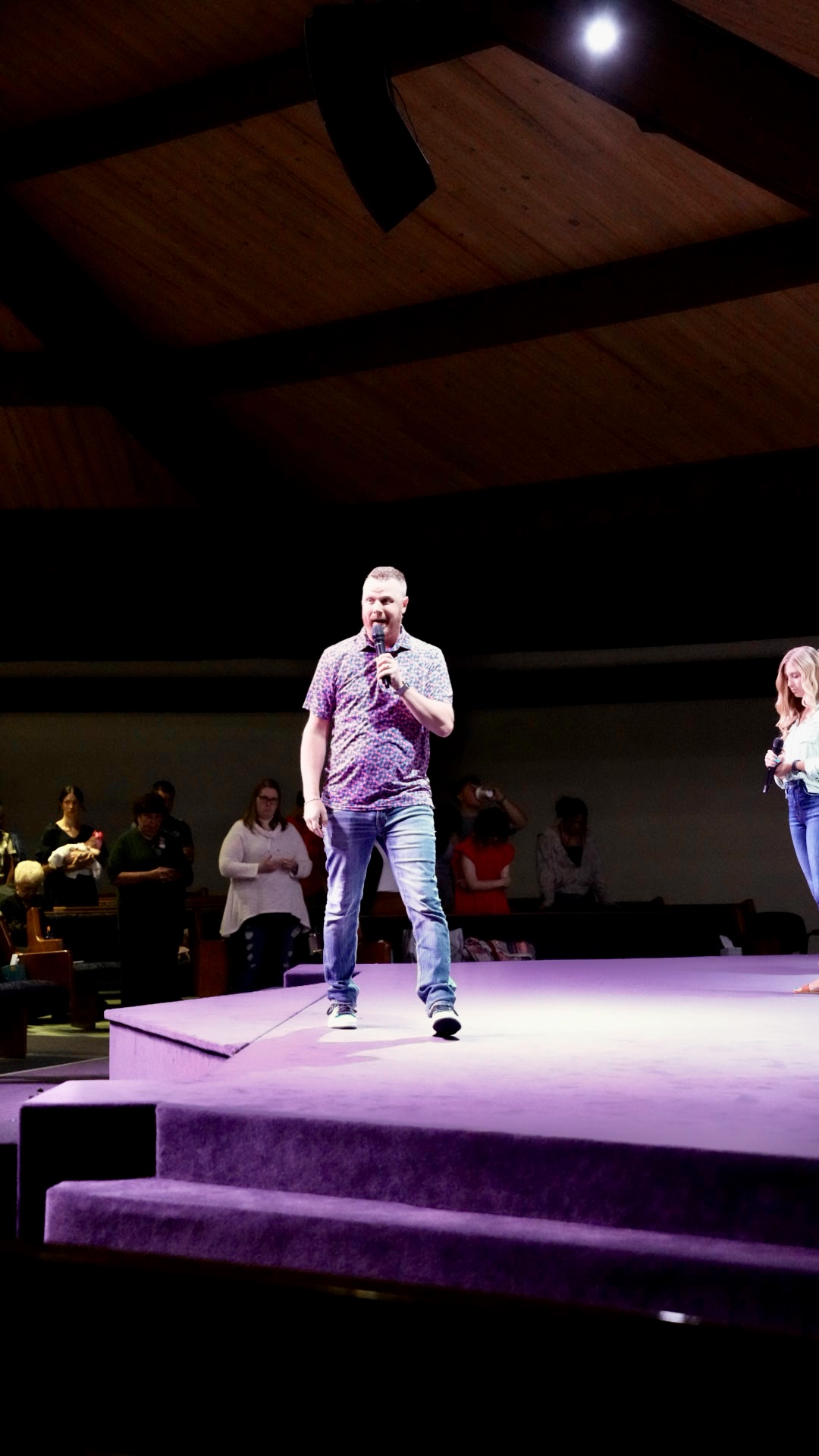 Pastor speaking on stage during a service
