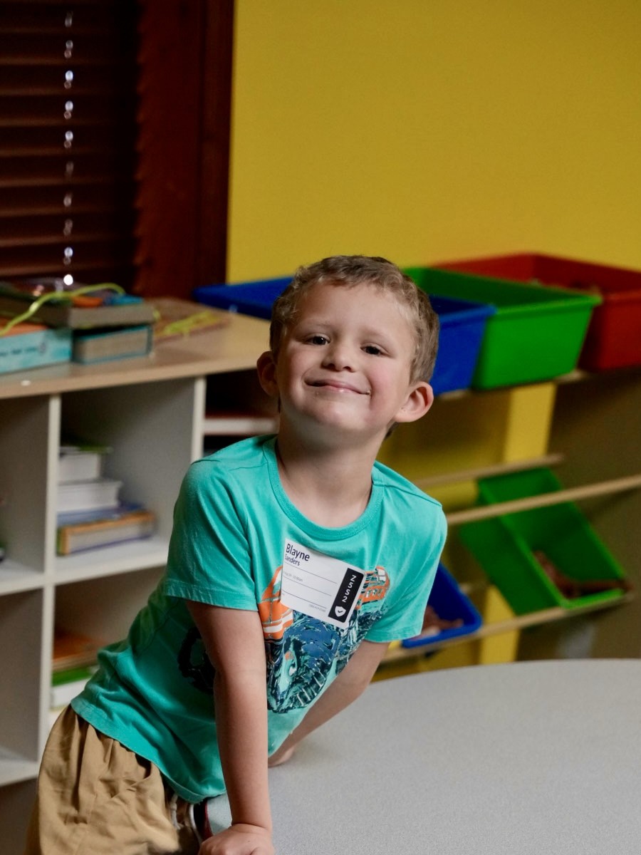 Young child smiling in the Sonshine Kids classroom at Grandview Church