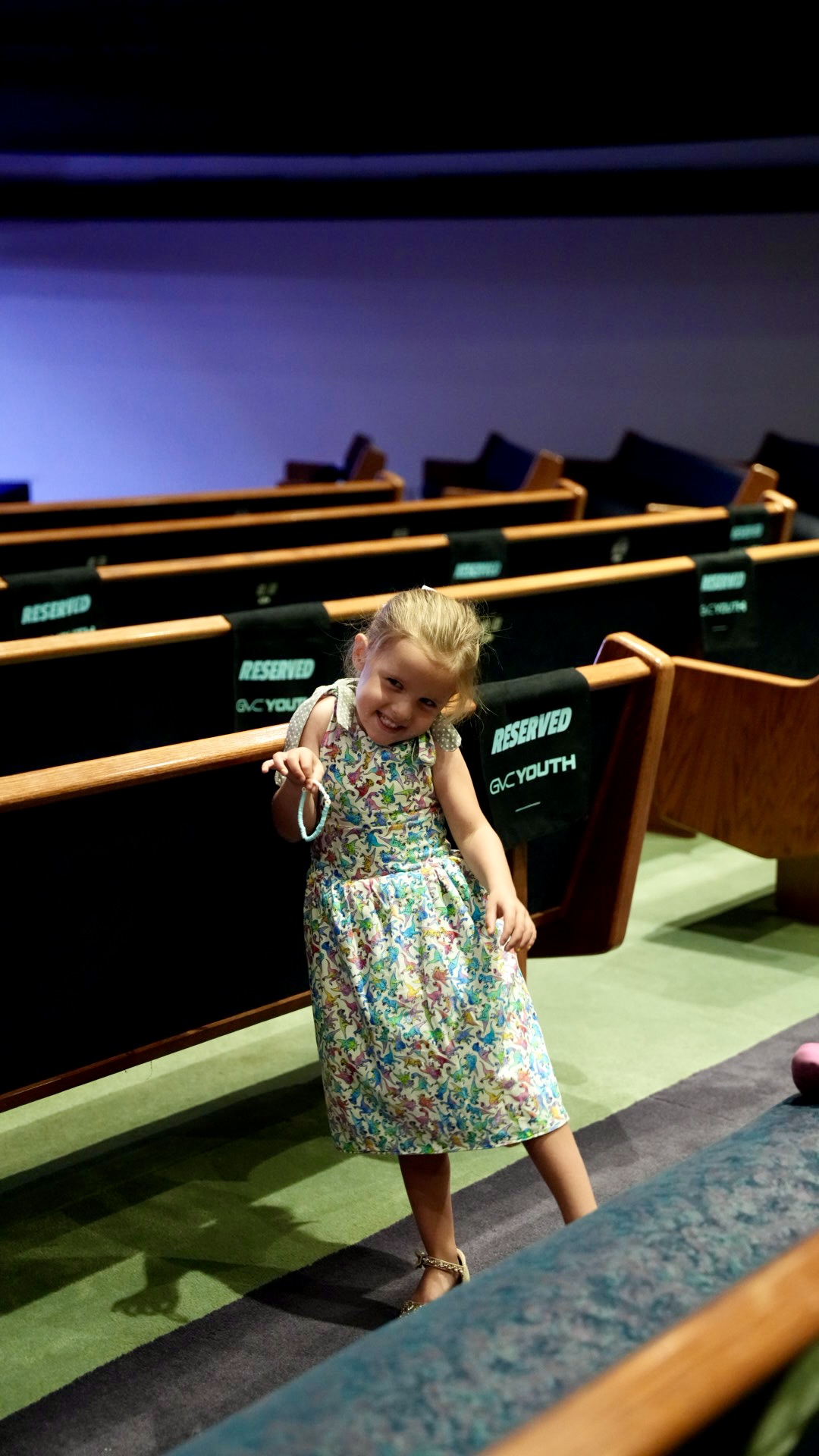 A little girl smiling in the sanctuary before service