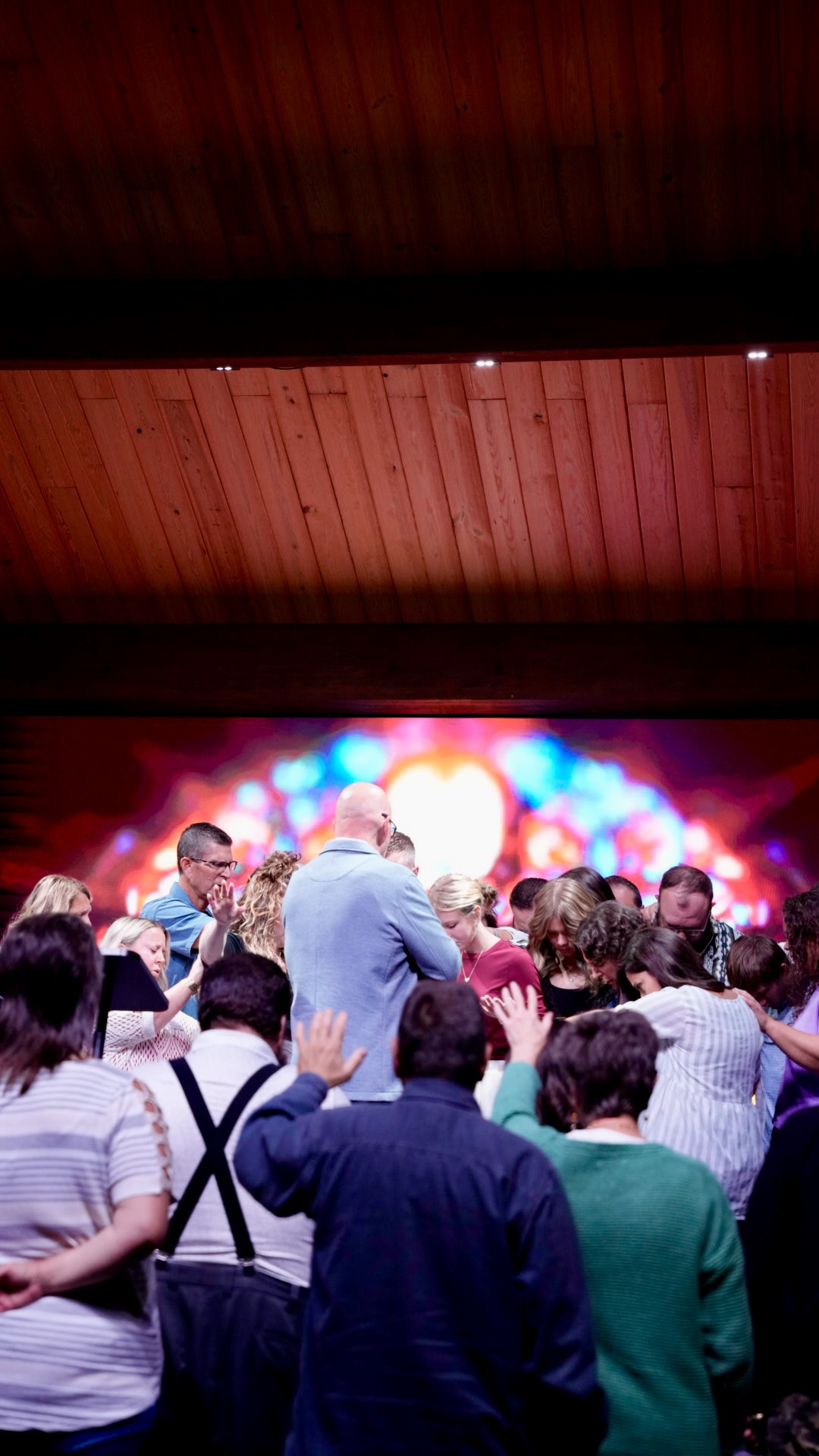 The church gathered at the altar in prayer