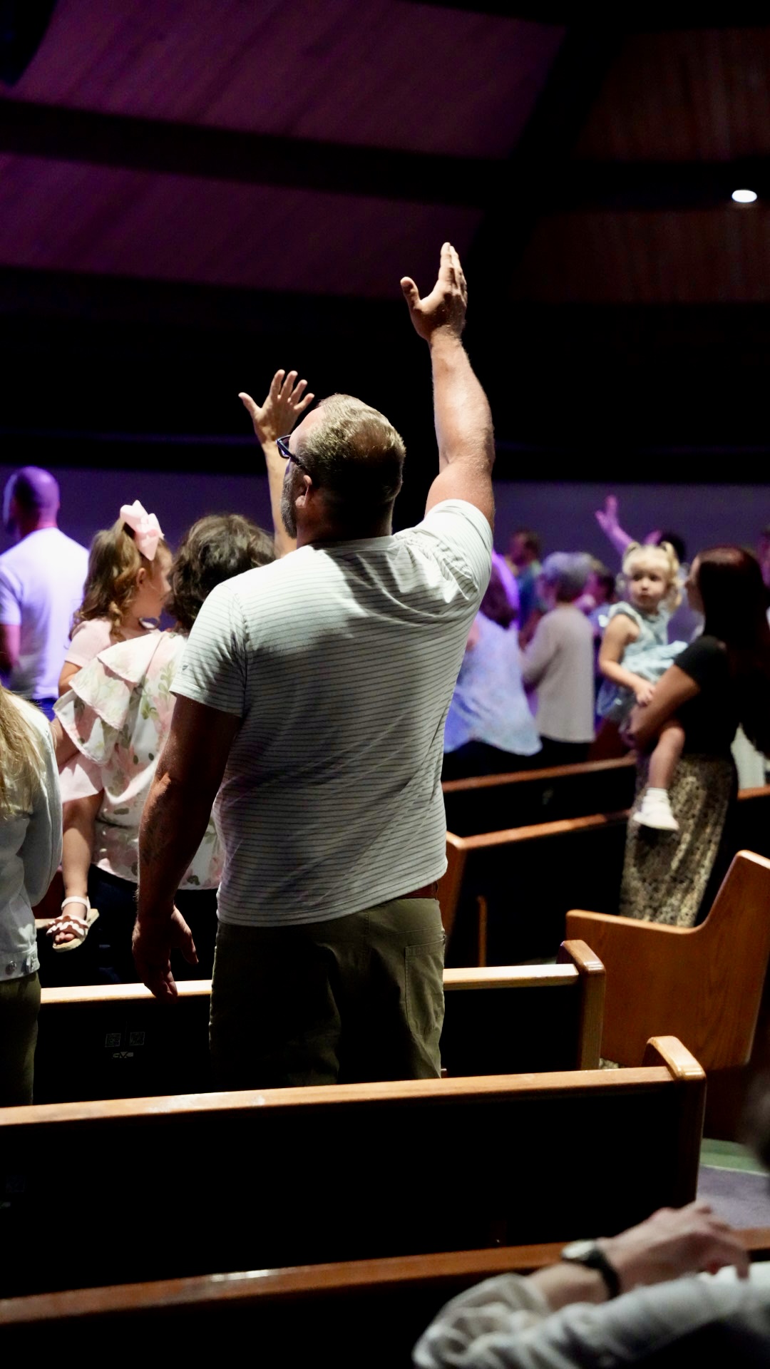 A man worshipping with hands lifted in the sanctuary