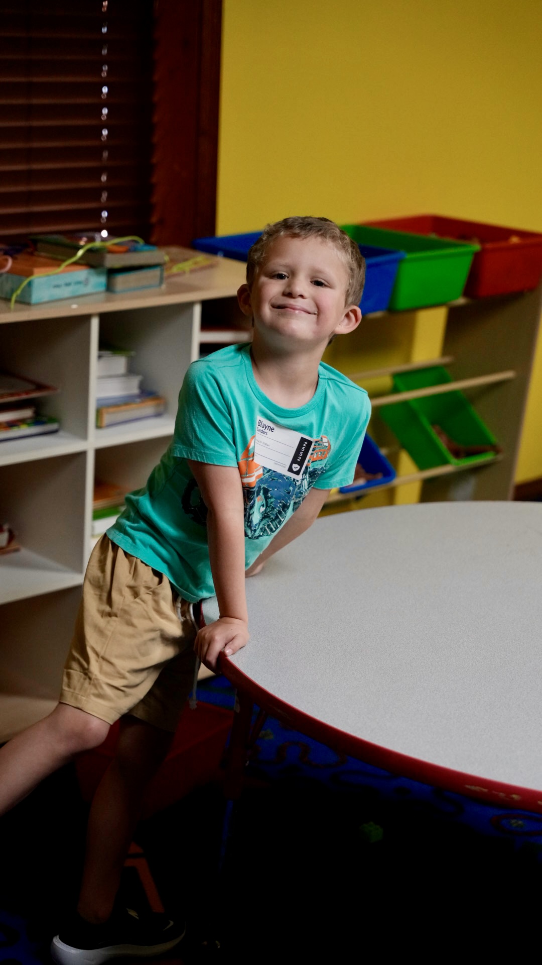 A boy smiling in the children's classroom